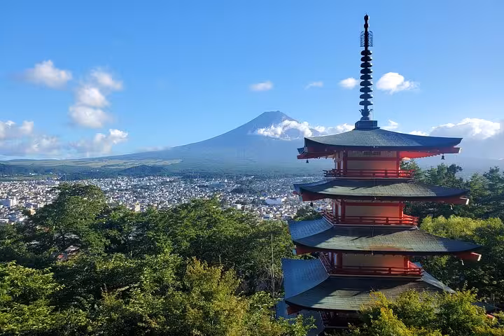 Iconic Chureito Pagoda with Mt. Fuji in the background under clear skies, offering a breathtaking panoramic view.