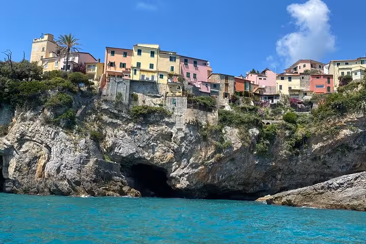 Colorful cliffside houses of Cinque Terre overlooking the turquoise sea on a clear day.