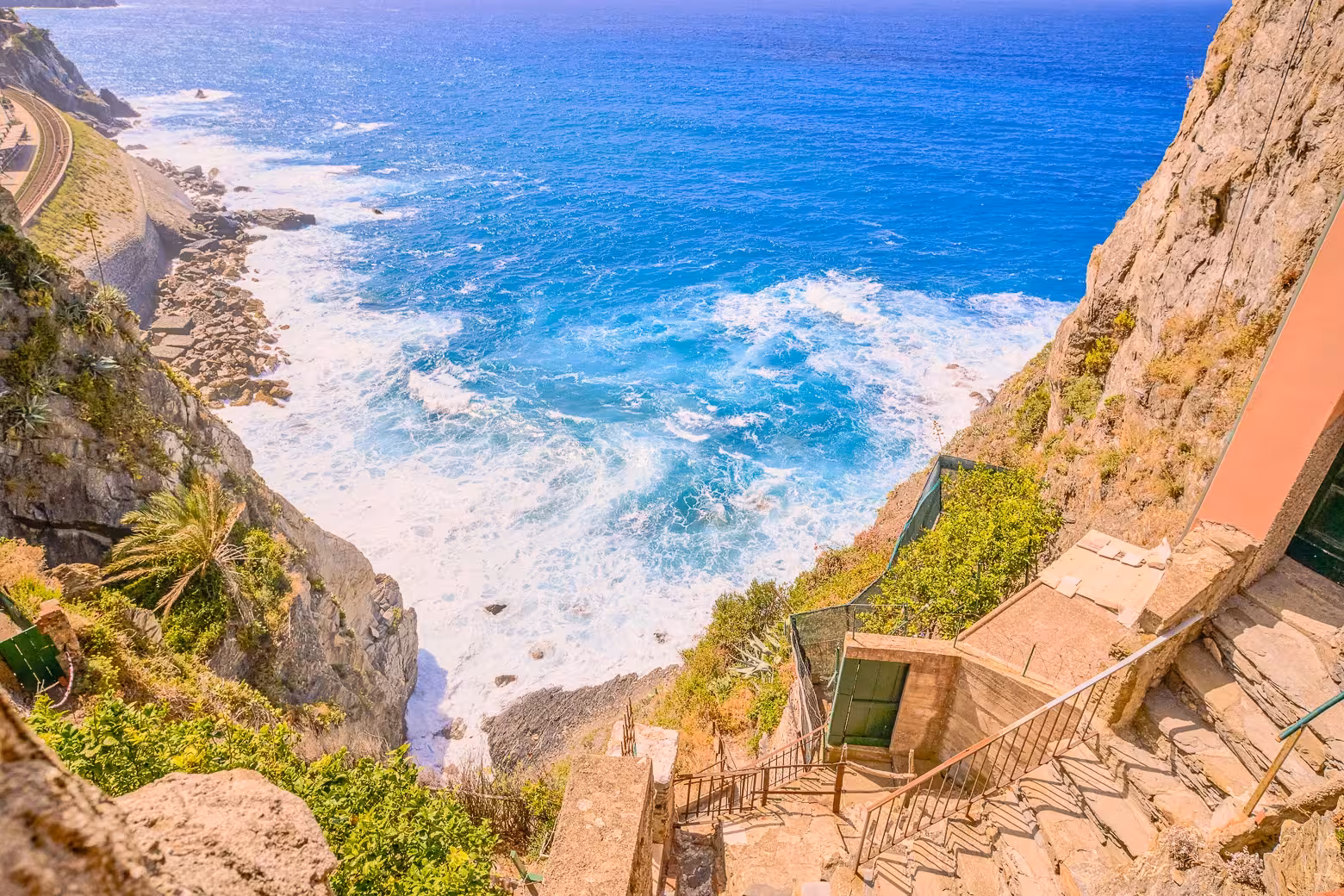 Stunning cliffside path with ocean waves in Cinque Terre, perfect for small group hiking adventures from La Spezia.
