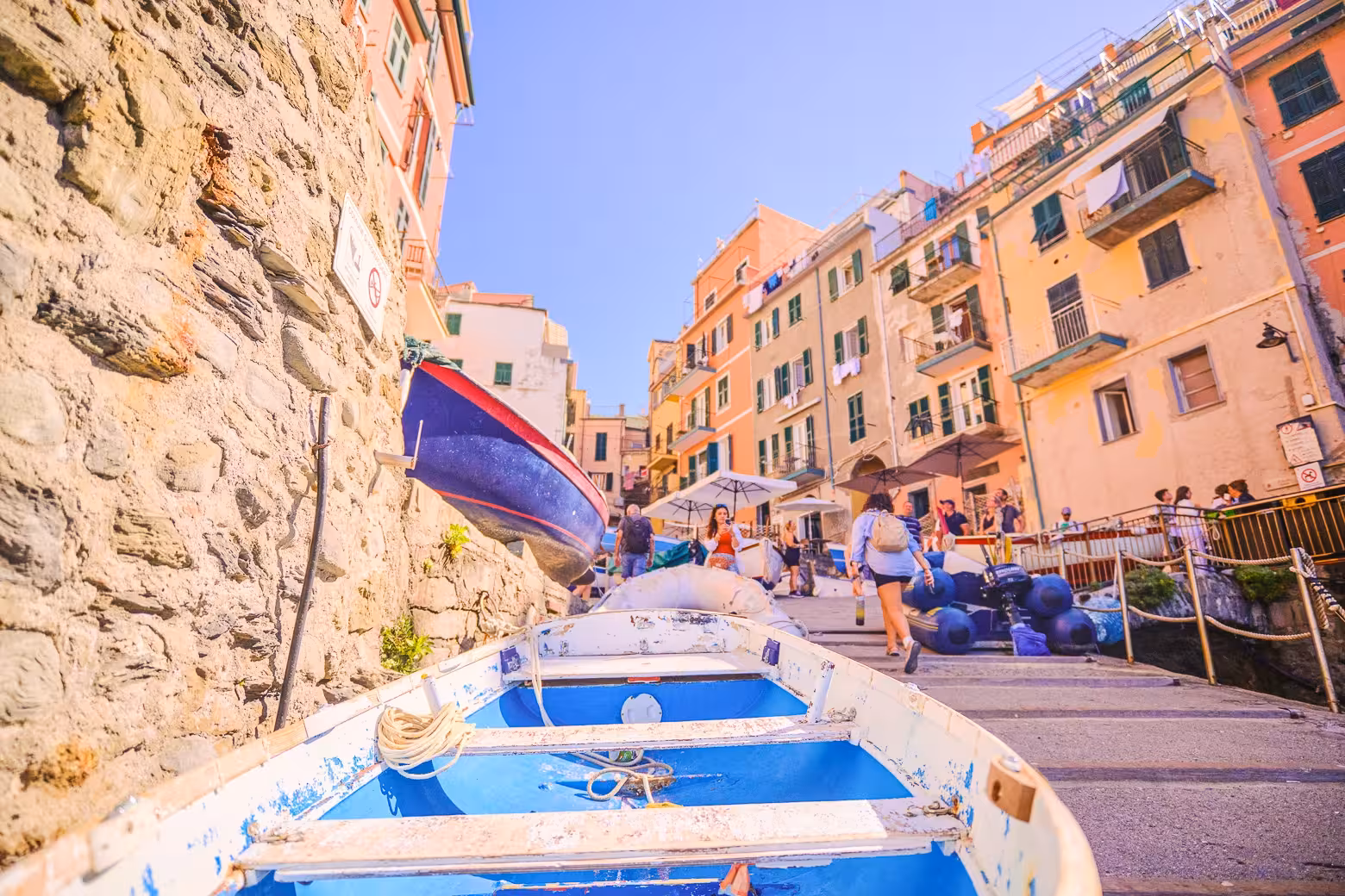Colorful boats and vibrant buildings in a picturesque Cinque Terre village, perfect for exploring on a day tour from Florence.