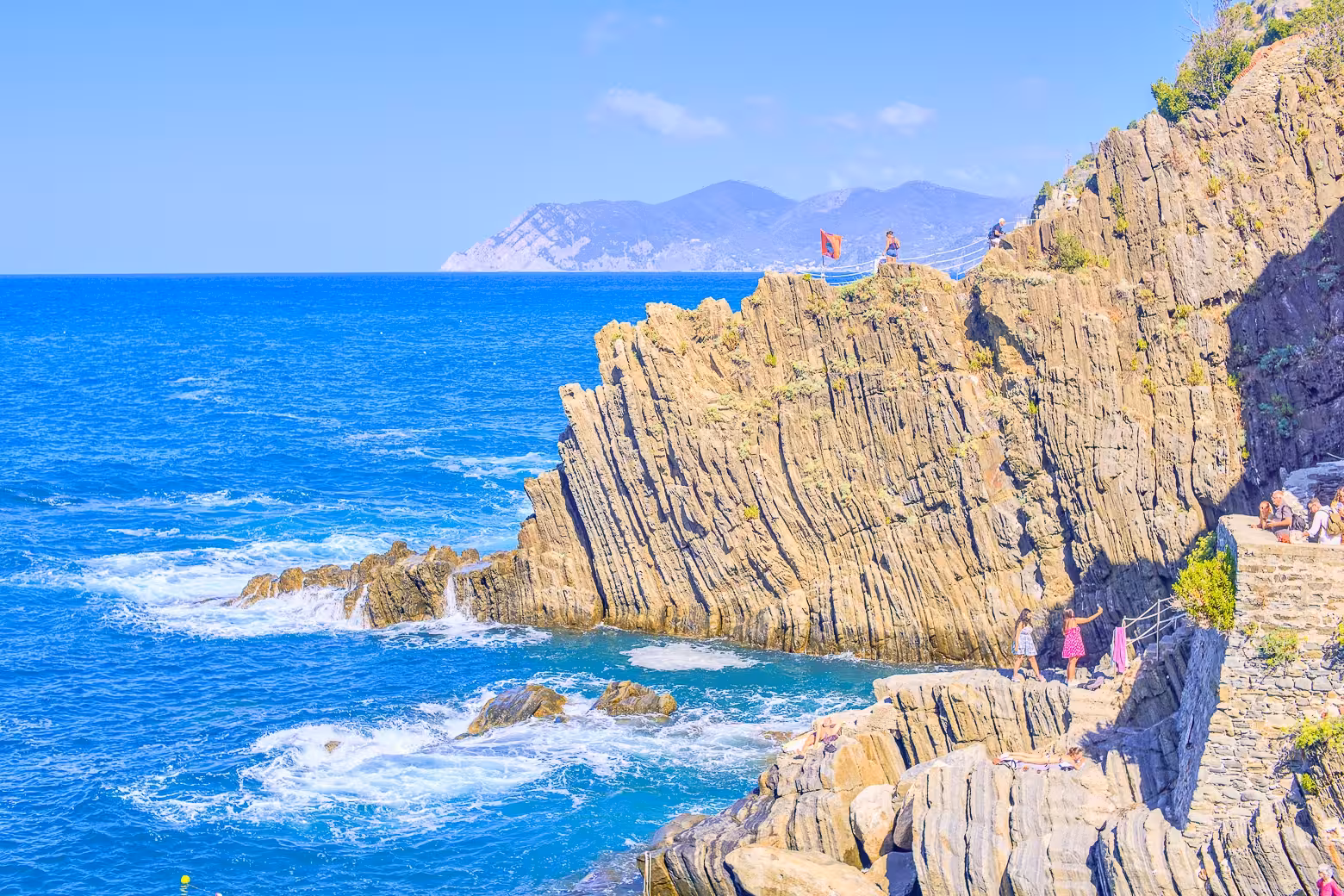 Rugged cliffs and blue sea view on Cinque Terre hiking trail from La Spezia port, perfect for small group tours.