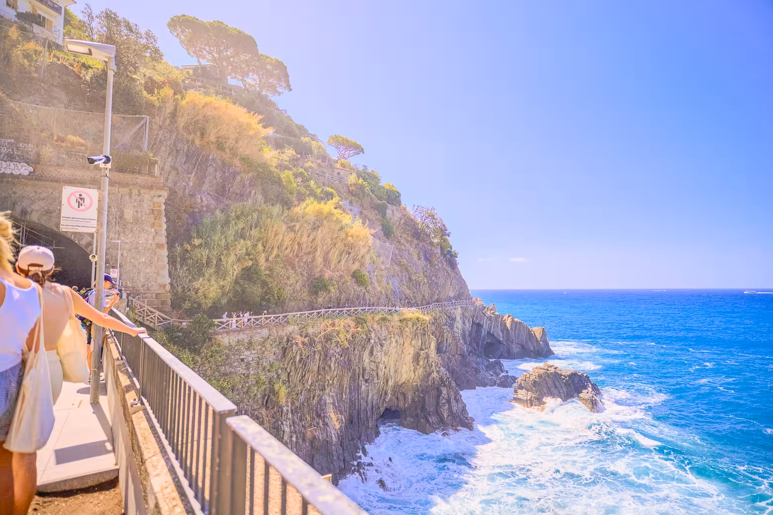 Hikers enjoy breathtaking coastal views and rugged cliffs on Cinque Terre trail during a small group tour from La Spezia.