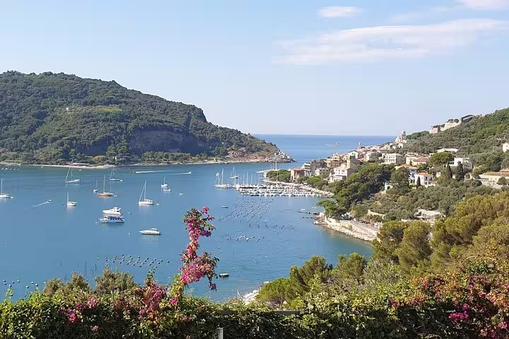 Panoramic view of La Spezia Gulf with sailboats, green hills and seaside villages on the Cinque Terre cruise transfer route