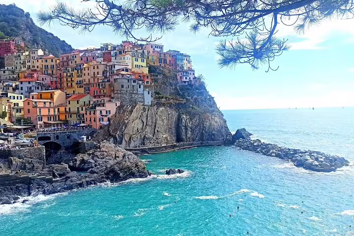 Colorful cliffside houses of Manarola above turquoise sea on scenic transfer from La Spezia to Cinque Terre and back to cruise ship