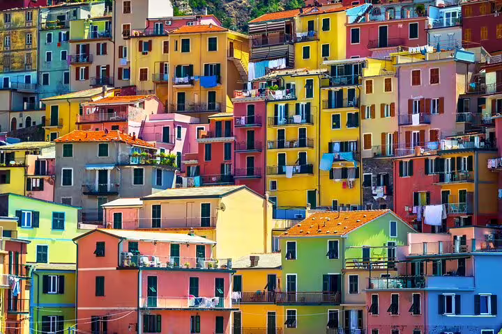Close-up of vibrant pastel houses stacked on a hillside in Cinque Terre, Italy, seen during a private Gulf of Poets tour