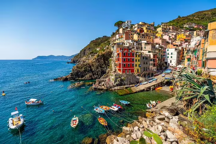 Colorful cliffside houses and fishing boats in Riomaggiore, Cinque Terre, seen on a private guided tour from La Spezia