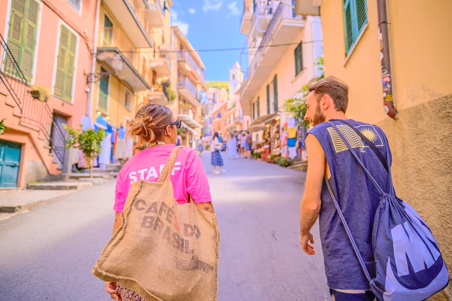 Tour participants stroll through vibrant streets of Cinque Terre, capturing local charm and culture.