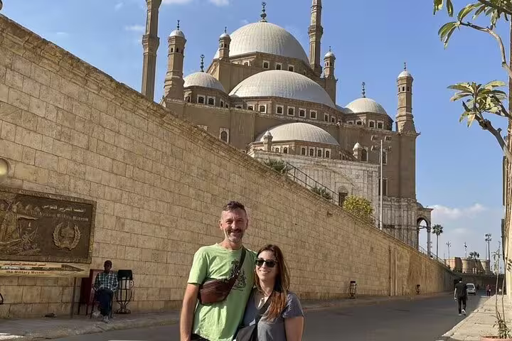 Couple at the Citadel of Saladin with Mohamed Ali Mosque domes, Cairo tour from Alexandria Port