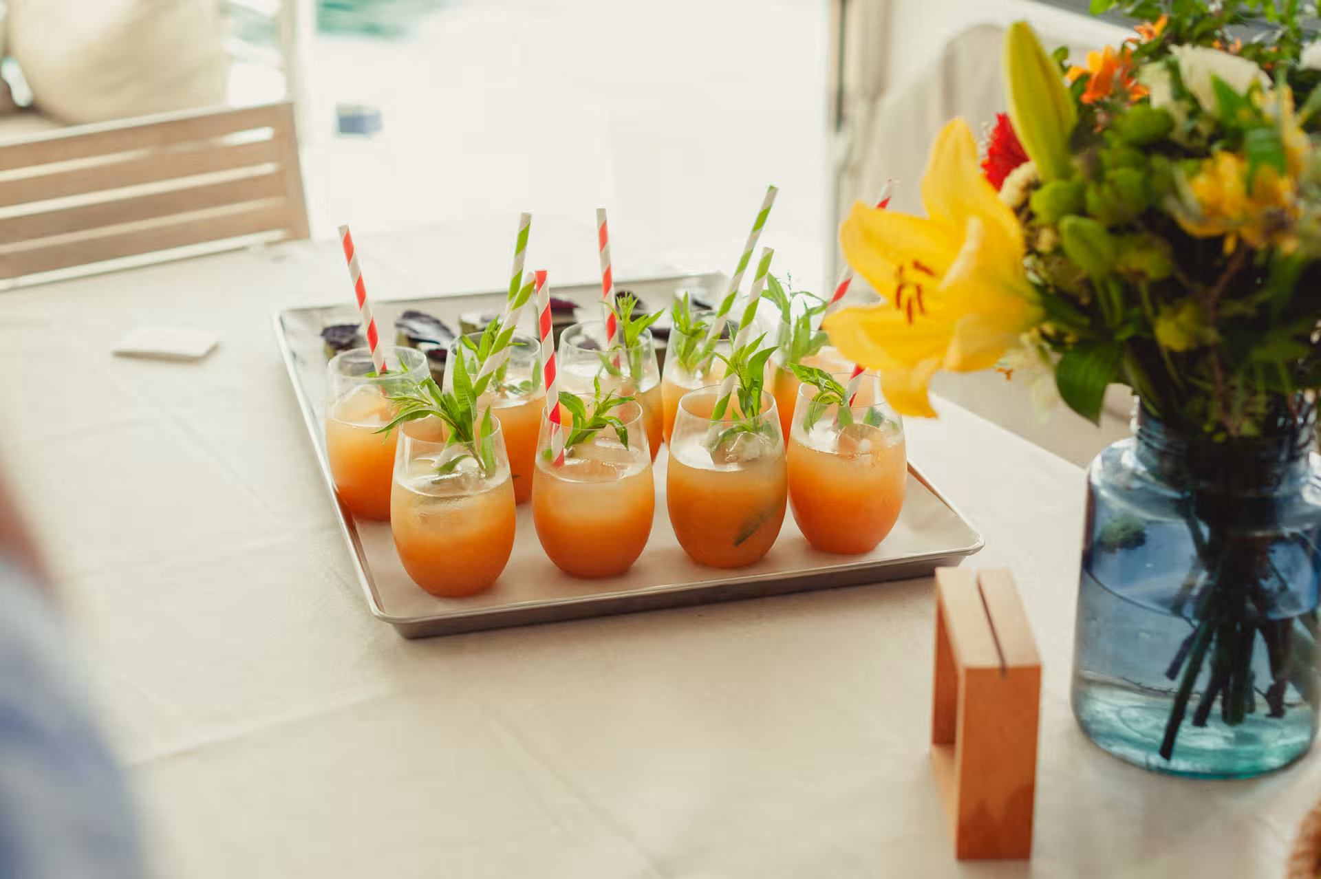 Refreshing citrus mocktails with herbs on a tray, perfect welcome drinks for a Wine & Art workshop