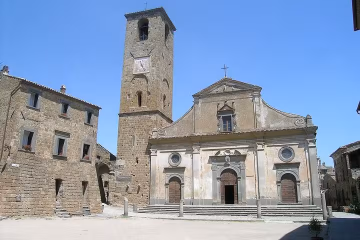 Explore the historic charm of Civita di Bagnoregio's stunning architecture on a private full-day tour with wine tasting.