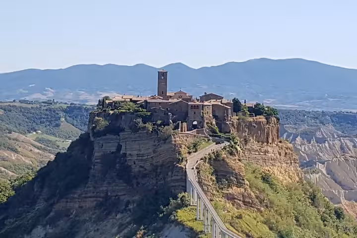 Hilltop medieval village of Civita di Bagnoregio on private Tuscany tour, dramatic cliffs and bridge view