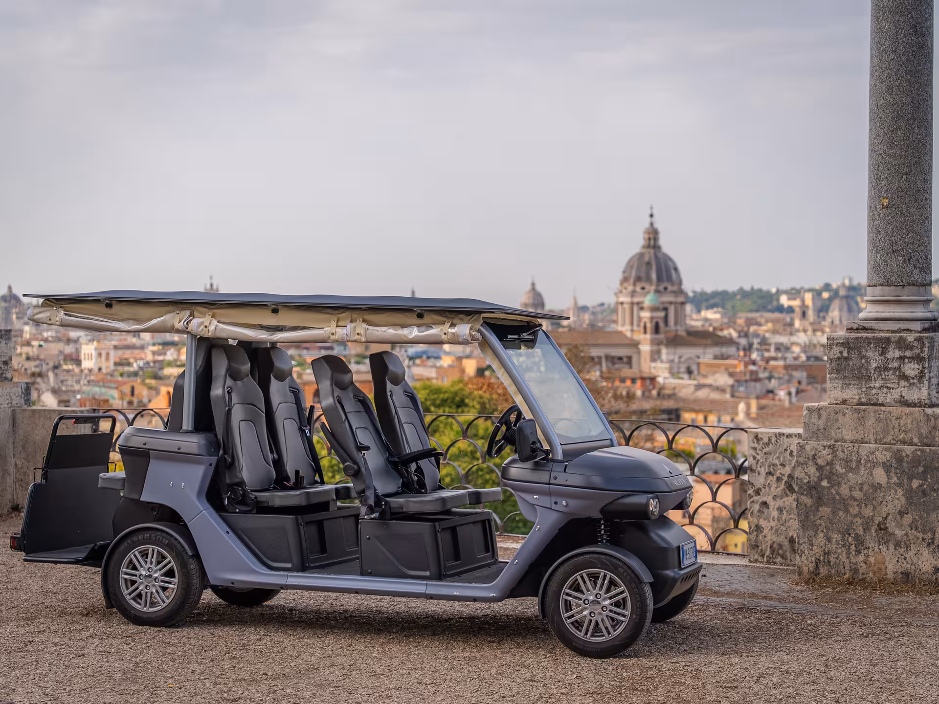 Luxury electric golf cart parked at a scenic Rome viewpoint on a private Civitavecchia to Rome VIP tour with Colosseum visit