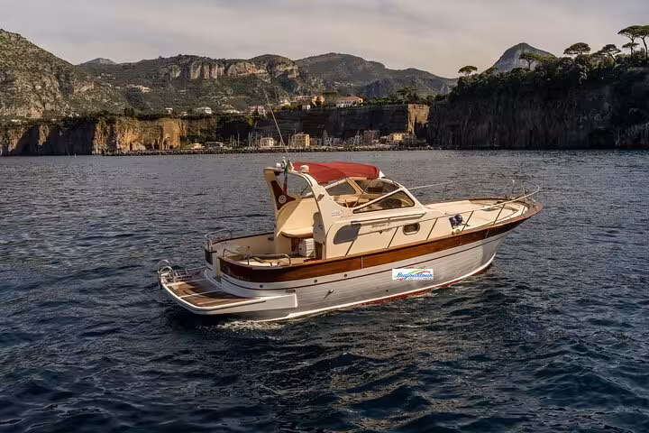 Classic Gozzo 8.50 boat cruising near Sorrento's coastline, ideal for private tours to Capri, offering luxury and comfort.