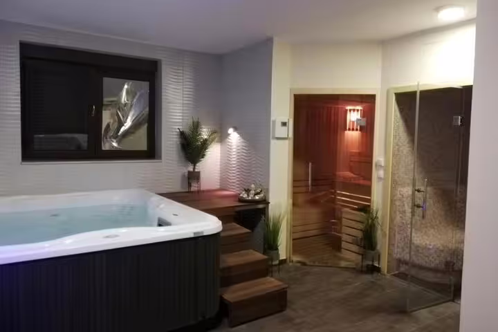 Cleopatra Deluxe VIP spa room with private jacuzzi, sauna, and rain shower for relaxing treatment