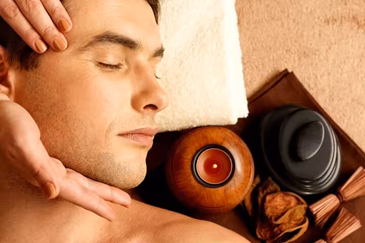 Guest enjoying soothing head and neck massage during Cleopatra’s Luxury Spa experience in Sharm El Sheikh