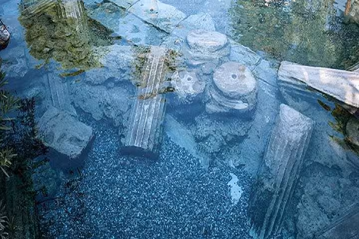 Ancient submerged ruins in Cleopatra Antique Pool, Hierapolis on Pamukkale tour with thermal spring water
