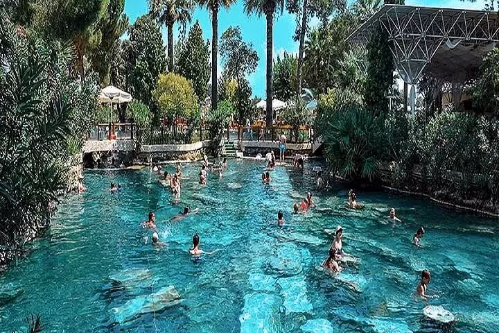 Swimmers in Cleopatra’s Antique Pool at Pamukkale, a highlight of the private full-day tour from Antalya