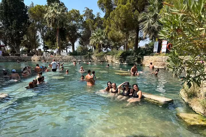 Travelers swimming in Cleopatra’s Pool at Pamukkale, a highlight of the 2-day Istanbul by plane tour