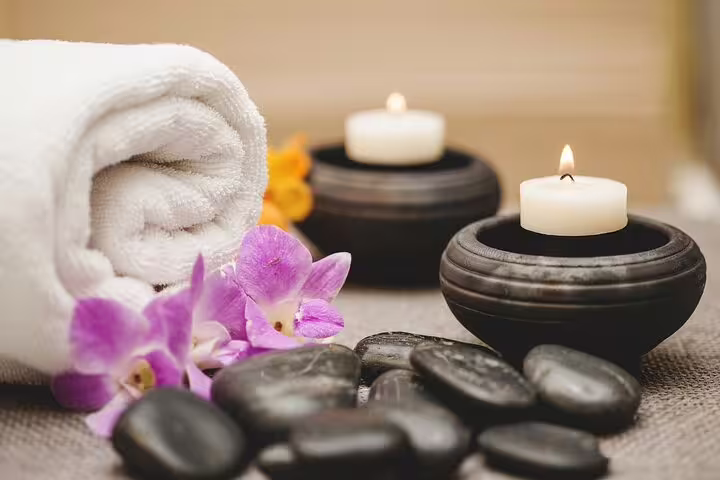 Spa candles, hot stones and rolled towel for Cleopatra Deluxe VIP treatment with sauna and jacuzzi