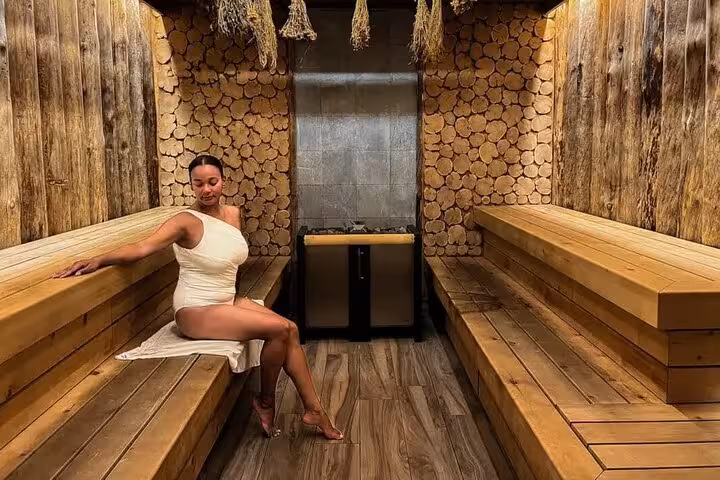 Woman relaxing in sauna at Hurghada Cleopatra Deluxe Spa, premium steam and heat therapy session