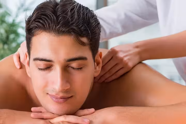 Guest enjoying shoulder and neck massage at Hurghada Cleopatra Deluxe Spa with sauna and jacuzzi access