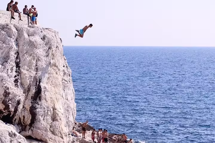 Cliff jumping into the Mediterranean near Marseille, adventure moment on a 3-day local tour experience