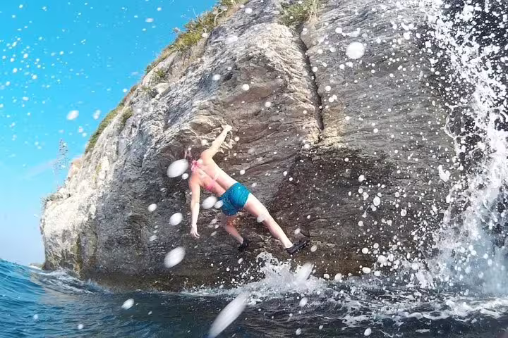 Adventurer splashes into the Adriatic after a cliff jump on a deep water solo tour in Split