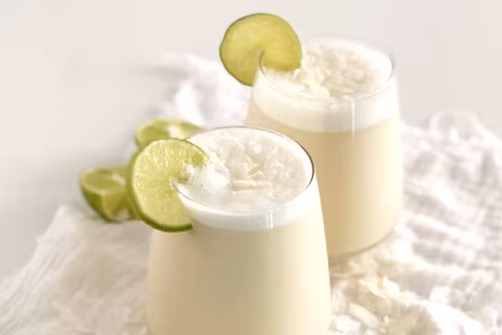 Refreshing coconut lime drinks in frosty glasses, showcasing Medellín's vibrant local beverage scene.