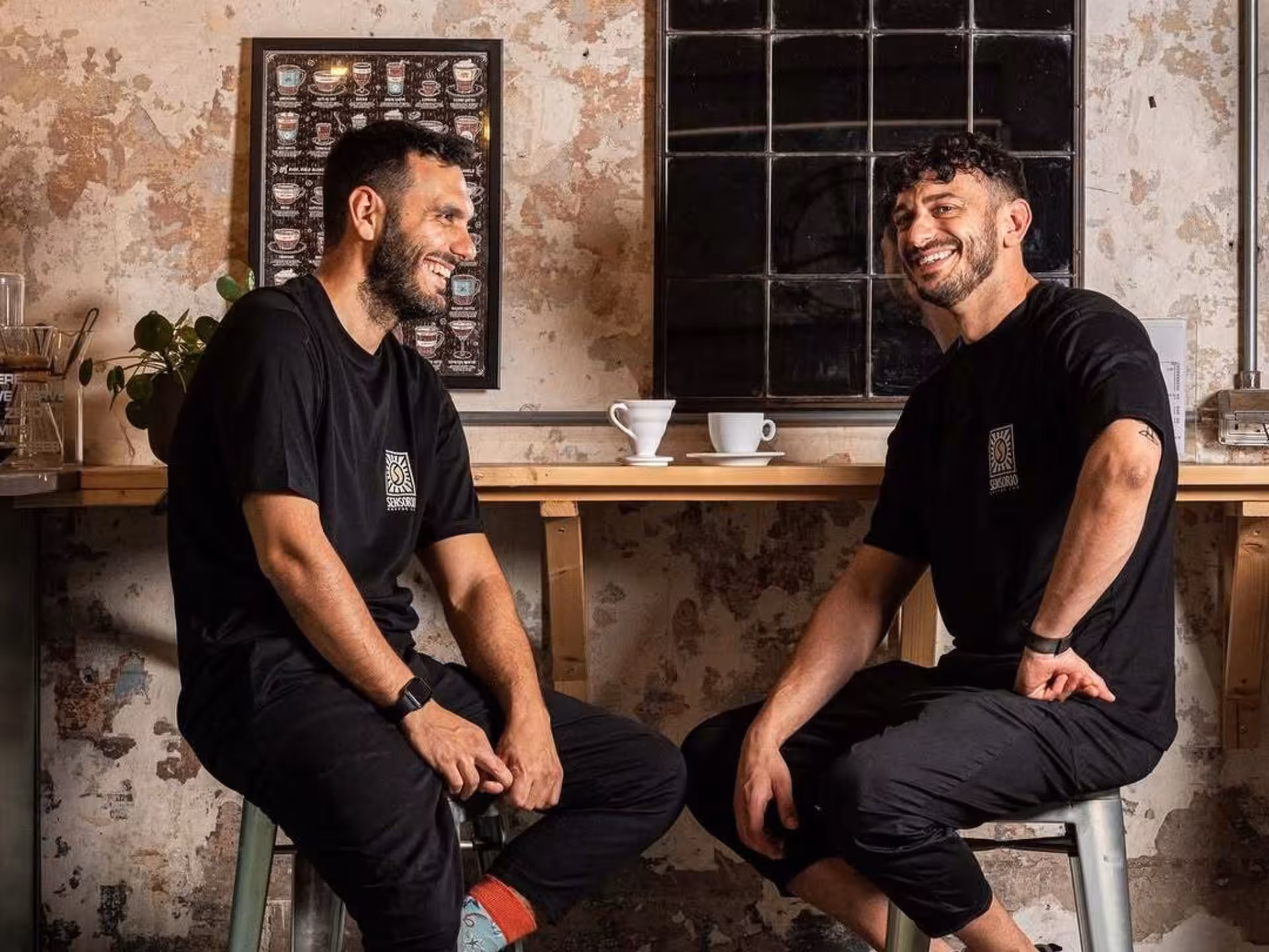 Two people enjoying a coffee workshop in a rustic Rome cafe.