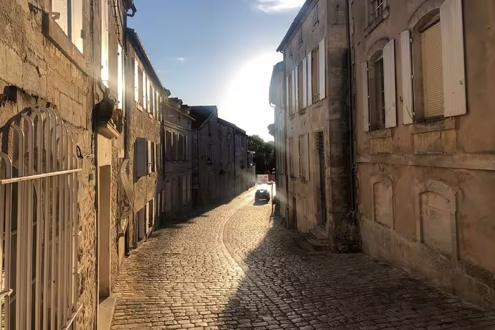 Sunlit cobblestone street in Cognac old town, perfect for a self-guided e-scavenger hunt city tour