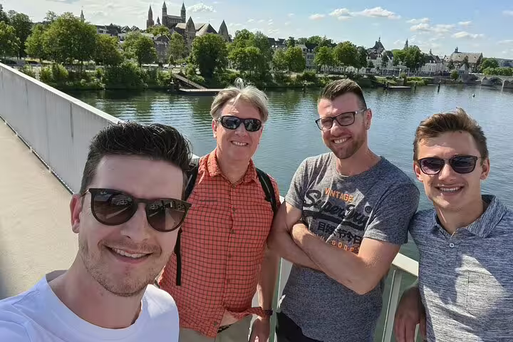 Group selfie on a bridge with river views on the Cognac e-Scavenger Hunt, a self-paced walking tour adventure