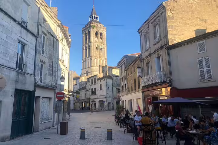 Cognac old town street with Saint-Léger church tower, ideal stop on a self-guided e-scavenger hunt tour