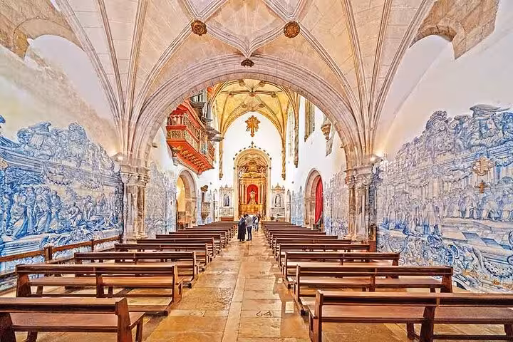 Beautiful interior of a Coimbra church featuring ornate azulejos and vaulted ceilings, ideal for cultural exploration.