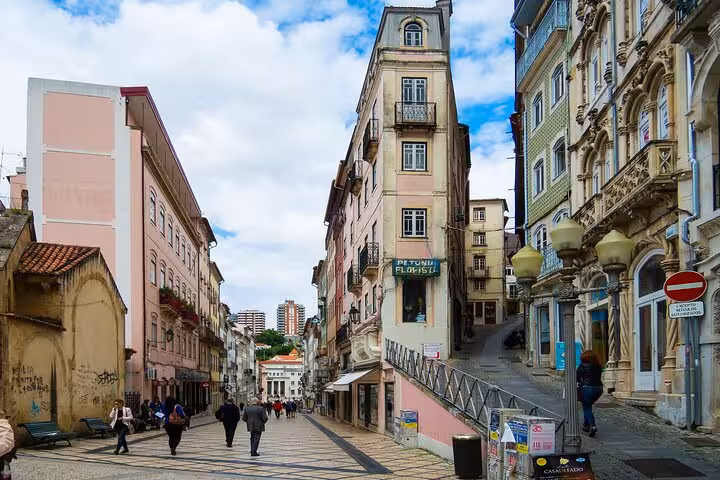 Charming street view of Coimbra's historic downtown with colorful buildings perfect for a private walking tour.