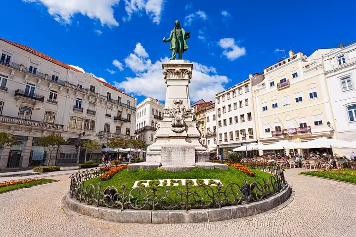Explore Coimbra's vibrant Largo da Portagem with its historic architecture on a private two-hour city walk.