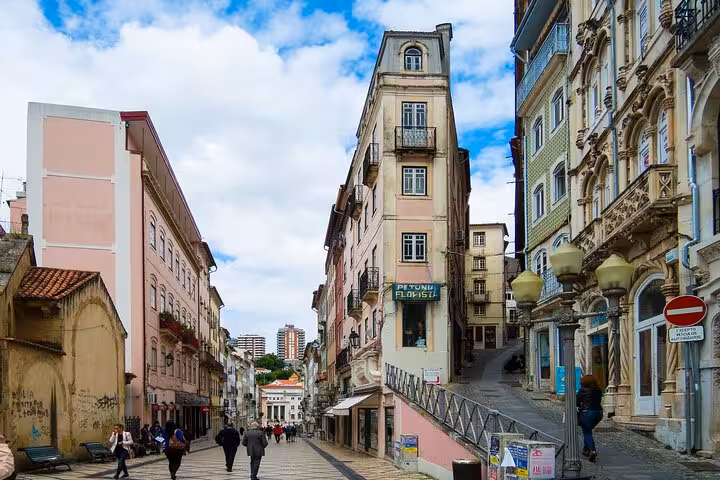 Charming street view in Coimbra with historic architecture, perfect for a private walking tour experience.