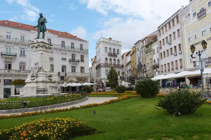 Charming square in Coimbra with historic architecture and lush gardens featured in Lisbon, Fatima & Coimbra 6 Day Tour from Porto.