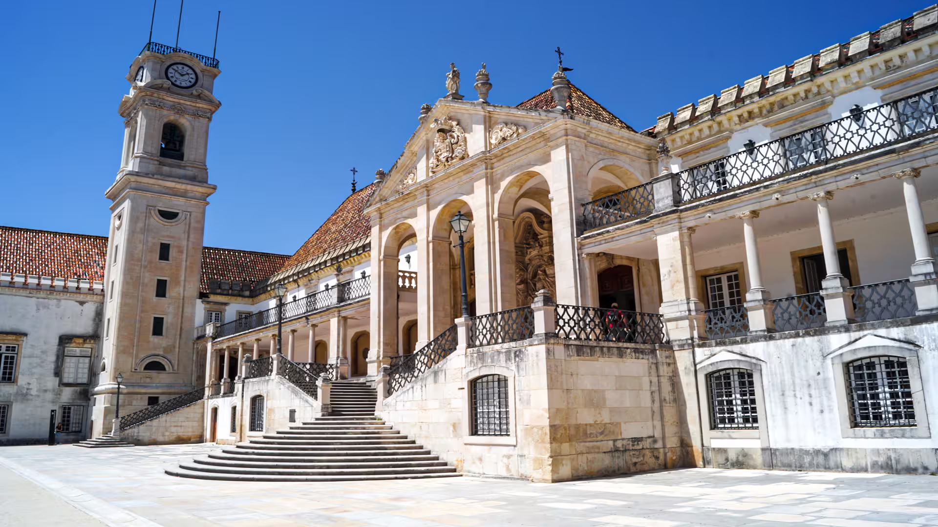 Historic University of Coimbra courtyard with ornate architecture, featured in private tour to ancient Roman city in Portugal.