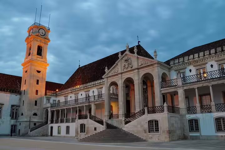 Historic University of Coimbra at dusk, showcasing stunning architecture on a Fatima and Coimbra private tour in Portugal.