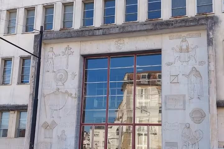 Intricate facade of Coimbra University building, showcasing historical carvings on the small group walking tour.