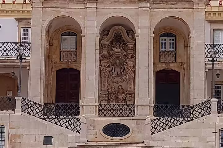 Elegant facade of a historic university building in Coimbra, showcasing cultural highlights of the tour.