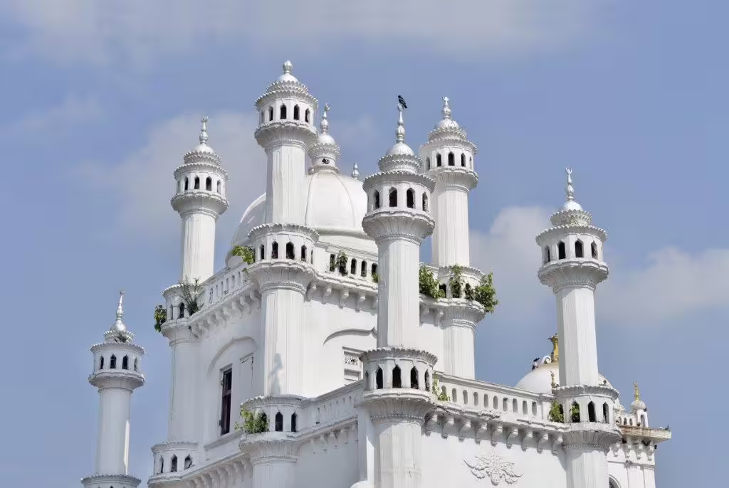 Stunning white minarets of a mosque against a clear blue sky, showcasing Colombo's rich architectural heritage.