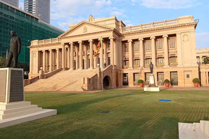 Colombo Old Parliament Building and Sri Lankan flag at sunset, a highlight on the Colombo City Tuk Tuk tour