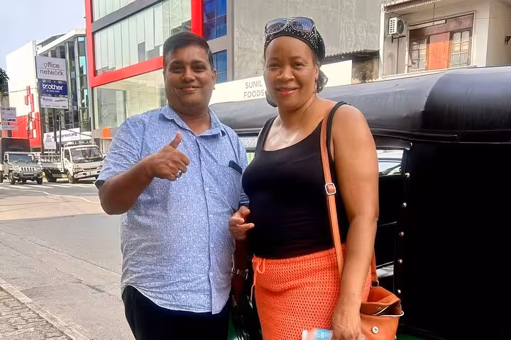 Happy guests with Colombo tuk tuk driver on an all-inclusive low price Royal City Colombo tour pickup