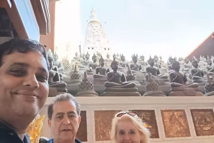 Tour guests inside Gangaramaya Temple with Buddha statues, Colombo tuk tuk city tour all inclusive low price