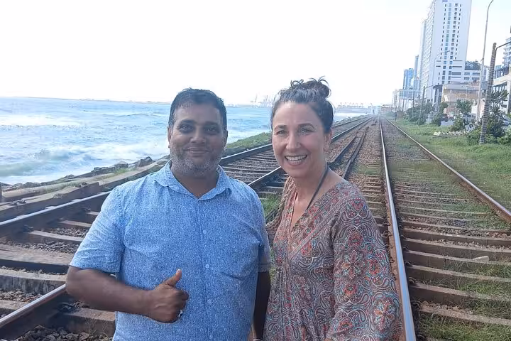 Guests with guide at Colombo marine drive railway tracks on Royal City Tuk Tuk all-inclusive city tour
