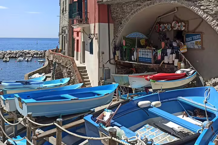 Colorful boats moored in Riomaggiore harbor, starting point for private Cinque Terre boat tours along the Italian Riviera