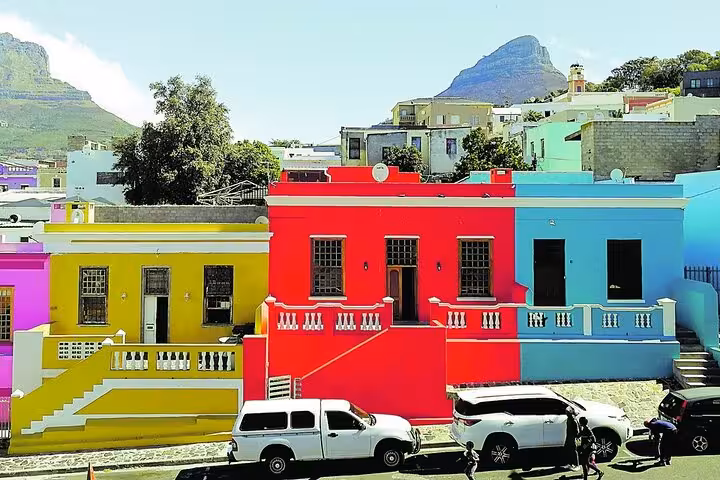Vibrant Bo-Kaap houses with Table Mountain backdrop, showcasing colorful Cape Town culture on Robben Island tour.