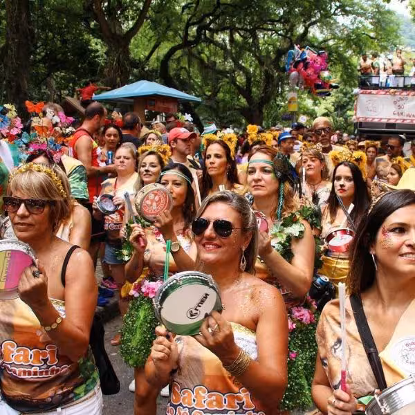Colorful crowd enjoying a lively samba parade at a bloco de rua in a festive carnival street party atmosphere.