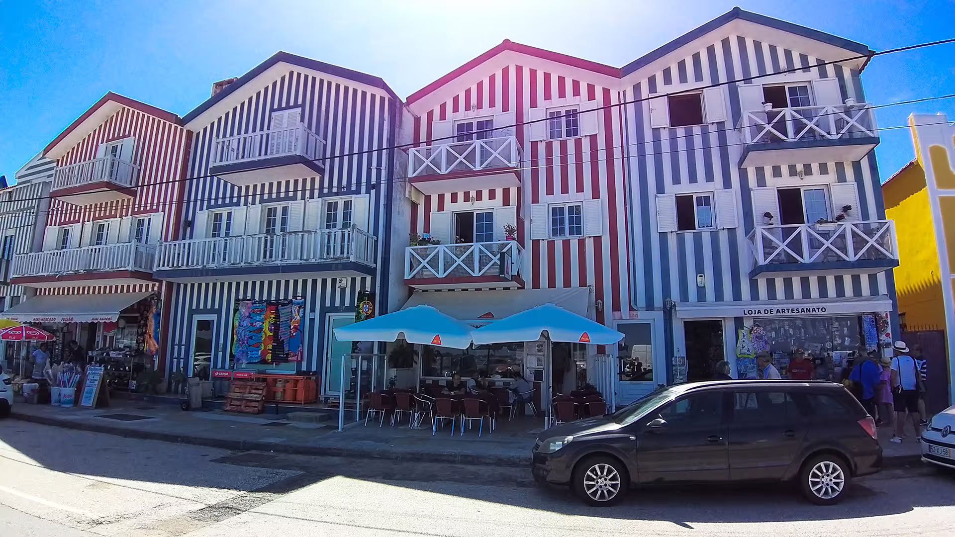 Colorful striped houses in Costa Nova, Portugal, showcasing unique architecture on a private tour to Aveiro and Costa Nova.